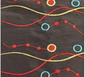 Black, yellow, red, and green taffeta wave and circle print tablecloth and runner.