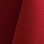 Bright red polyester tablecloth, runner, sash, and dinner napkin.