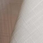 Ivory textured dinner napkin.