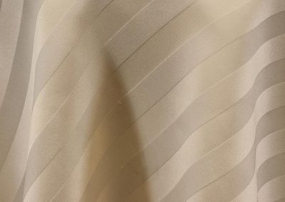 Ivory satin stripe tablecloth.