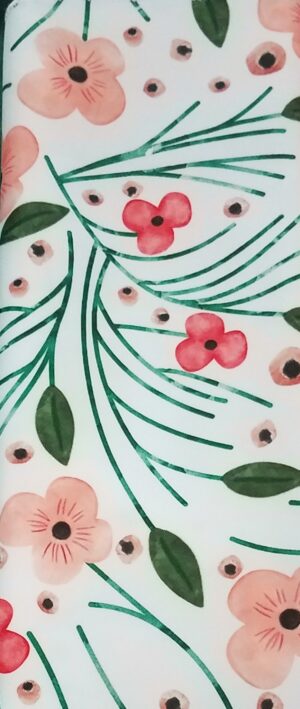 Peach, coral, and green floral print polyester dinner napkin on a white background.