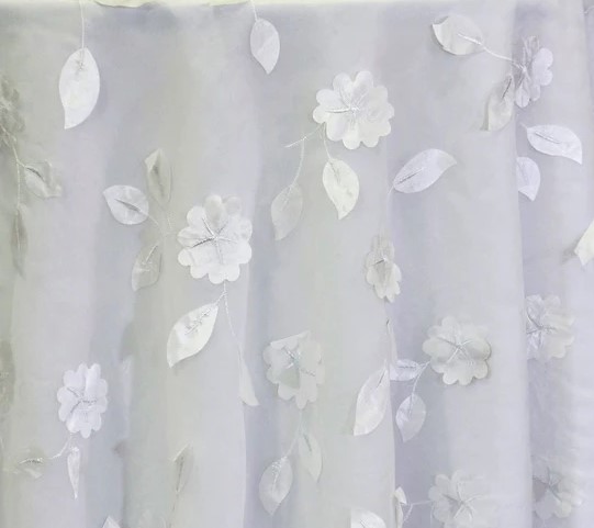 White dimensional floral print tablecloth.